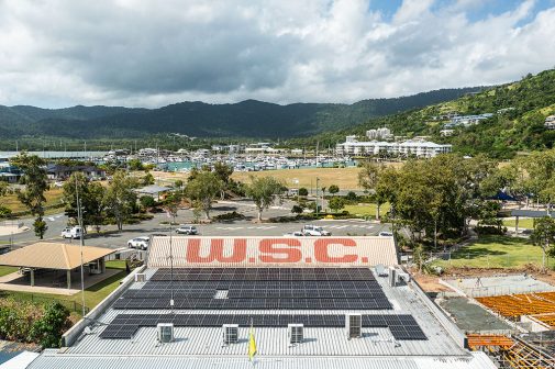 Aerial view of a commercial building with solar panels — Solar Power Systems in Proserpine, QLD