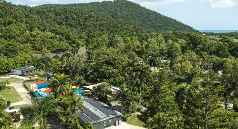 Solar panels on a house surrounded by trees — Solar Power Systems in Whitsundays QLD